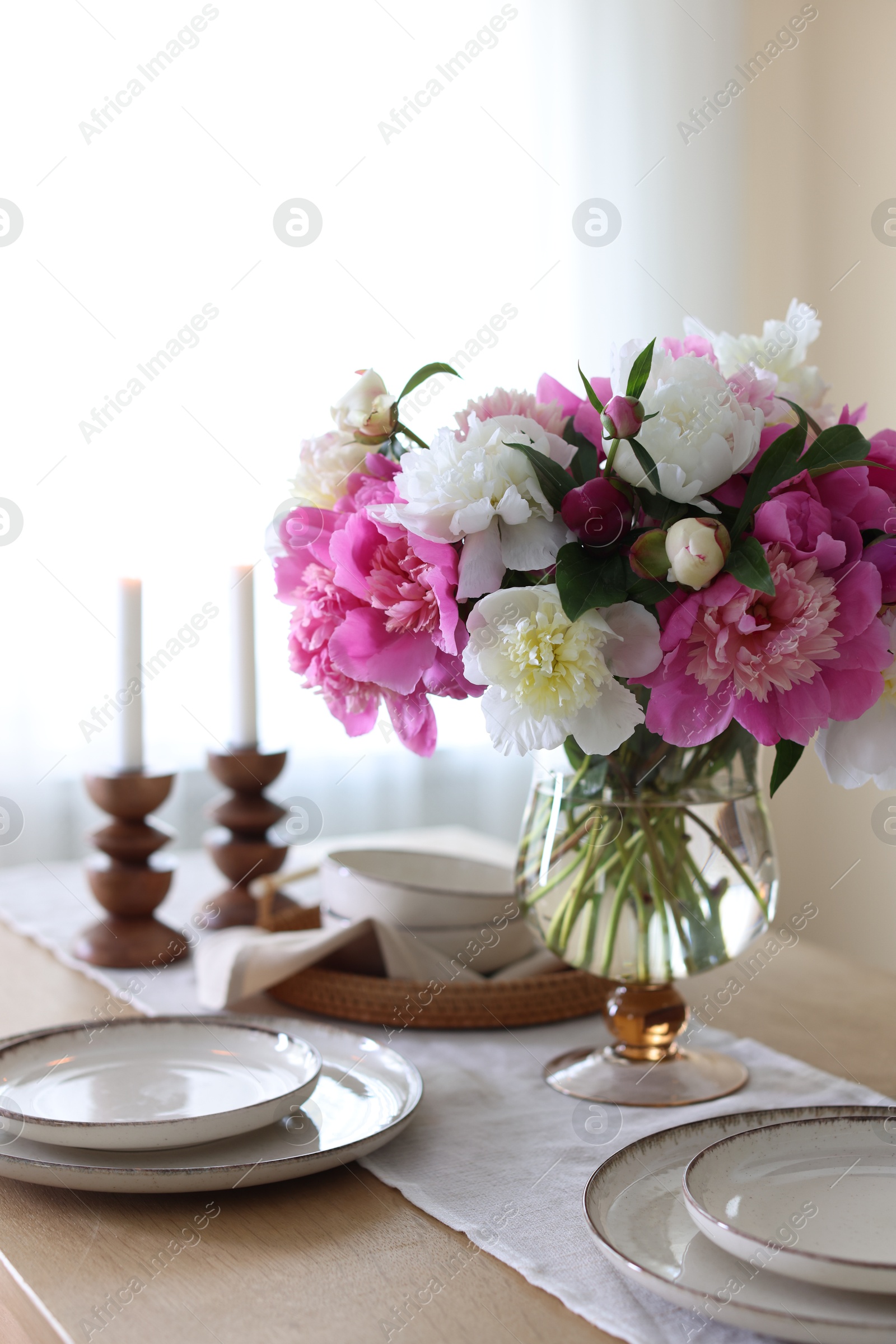 Beautiful table setting with bouquet of peonies indoors, closeup Photo of Beautiful table setting with bouquet of peonies indoors, closeup