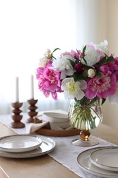 Photo of Beautiful table setting with bouquet of peonies indoors, closeup