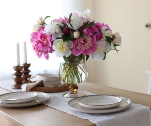 Photo of Beautiful table setting with bouquet of peonies indoors, closeup