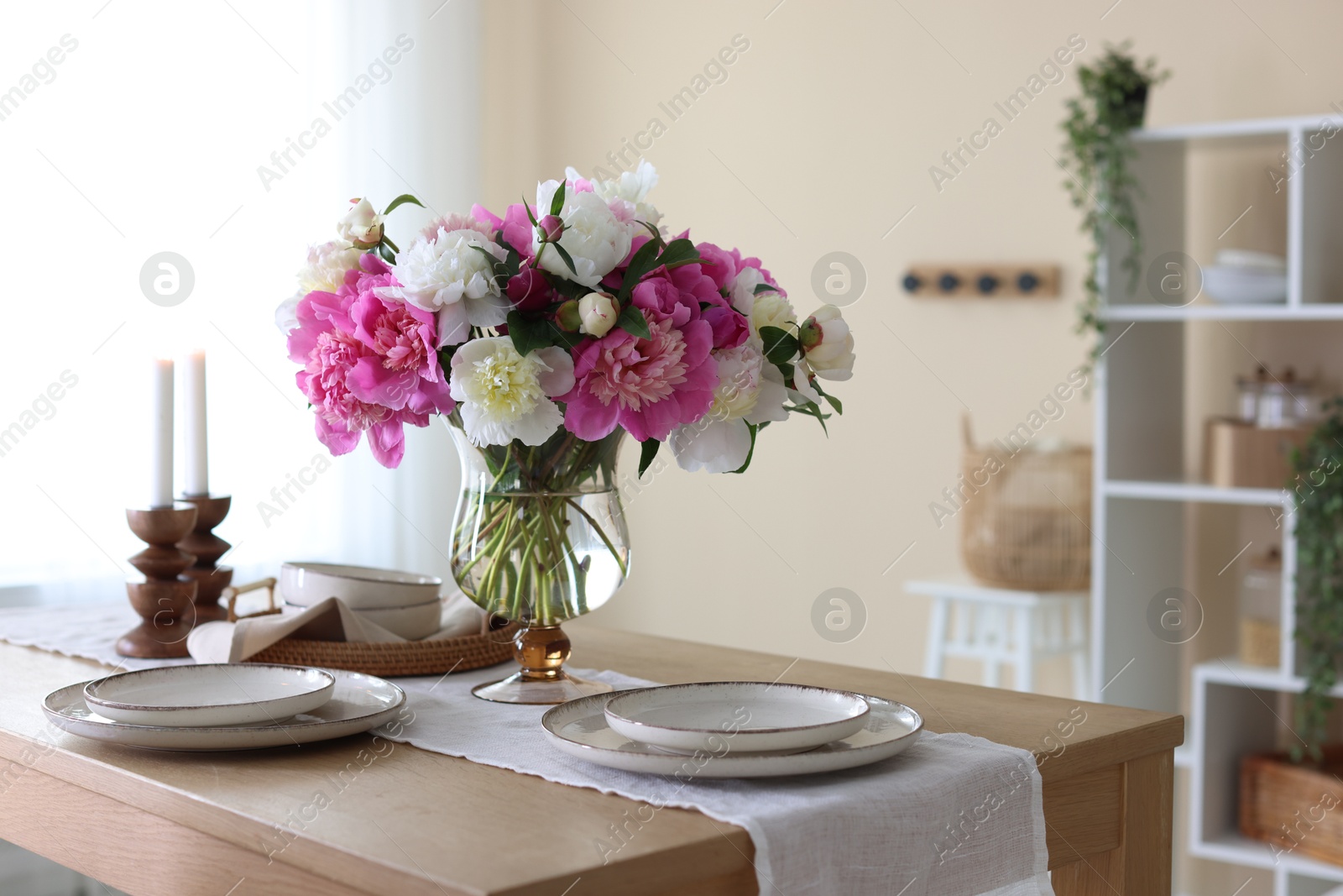 Beautiful table setting with bouquet of peonies in dining room Photo of Beautiful table setting with bouquet of peonies in dining room