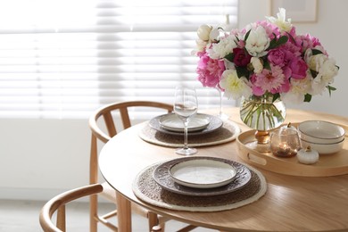 Photo of Beautiful table setting with bouquet of peonies in dining room. Space for text