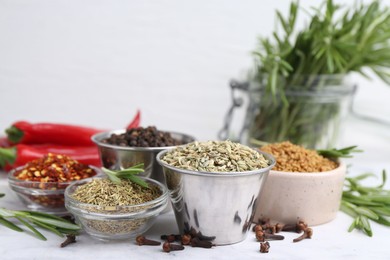 Photo of Different aromatic spices on white table, closeup