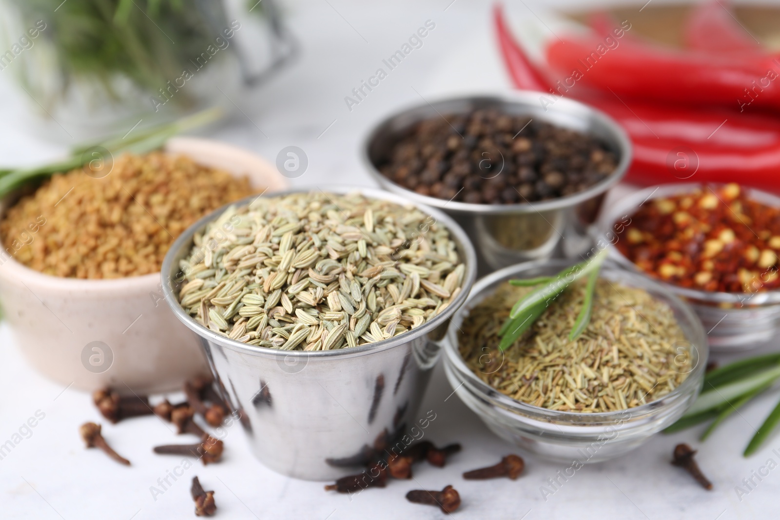 Different aromatic spices on white table, closeup Photo of Different aromatic spices on white table, closeup