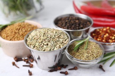 Photo of Different aromatic spices on white table, closeup