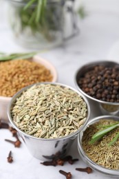 Photo of Different aromatic spices on white table, closeup