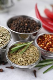 Photo of Different aromatic spices on white table, closeup