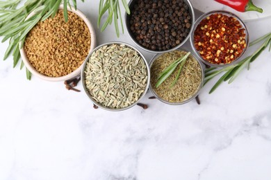 Photo of Different aromatic spices on white marble table, flat lay. Space for text
