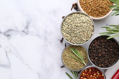Photo of Different aromatic spices on white marble table, flat lay. Space for text
