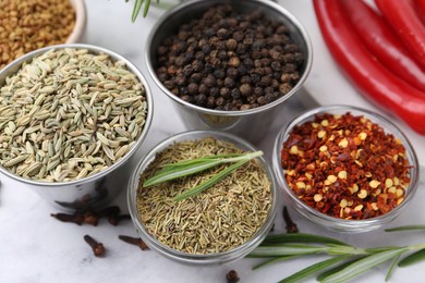 Photo of Different aromatic spices on white table, closeup