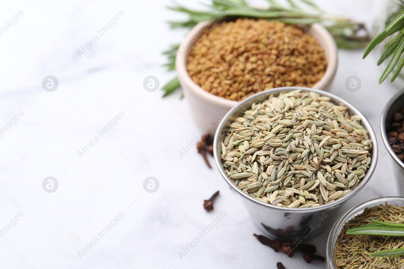 Different aromatic spices on white table, closeup. Space for text Photo of Different aromatic spices on white table, closeup. Space for text