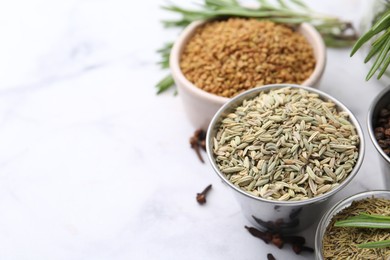 Photo of Different aromatic spices on white table, closeup. Space for text