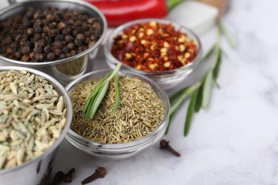 Photo of Different aromatic spices on white table, closeup