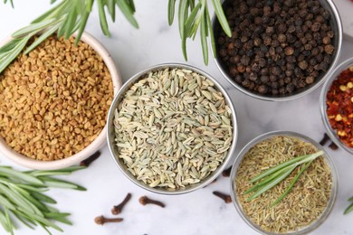 Photo of Different aromatic spices on white table, flat lay