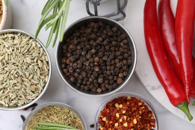Photo of Different aromatic spices on white table, flat lay