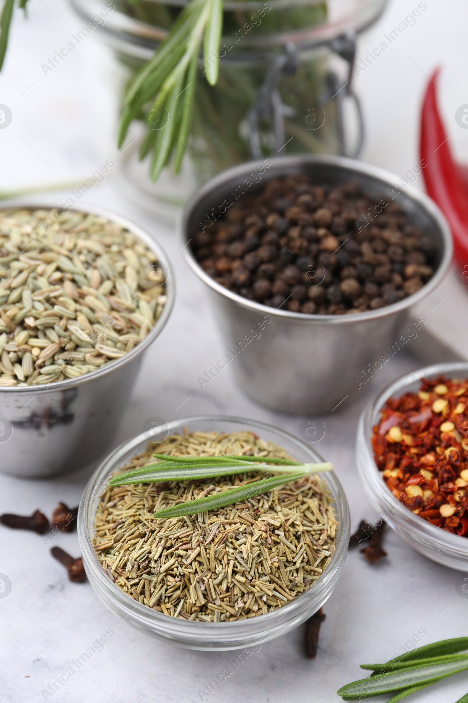 Different aromatic spices on white table, closeup Photo of Different aromatic spices on white table, closeup