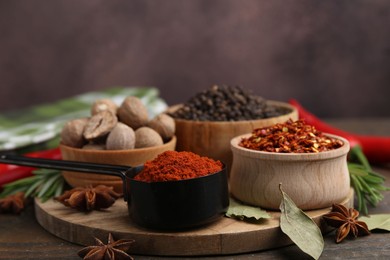 Photo of Many different aromatic spices on wooden table