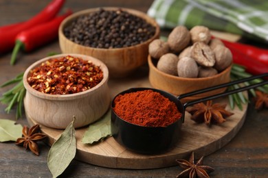 Photo of Many different aromatic spices on wooden table