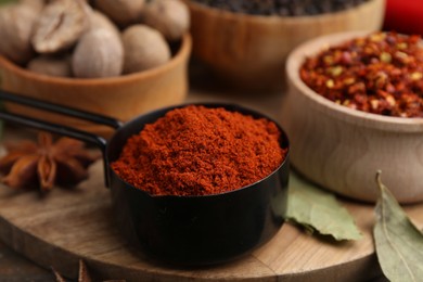 Photo of Different aromatic spices on wooden table, closeup