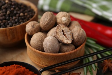 Photo of Different aromatic spices on wooden table, closeup