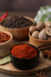Photo of Different aromatic spices on wooden table, closeup