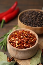 Photo of Different aromatic spices on wooden table, closeup