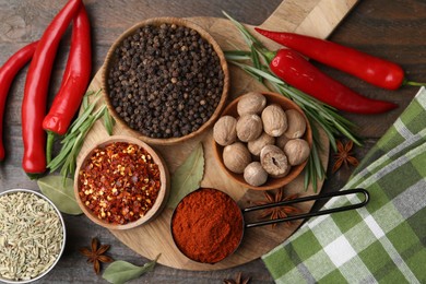 Photo of Different aromatic spices on wooden table, flat lay