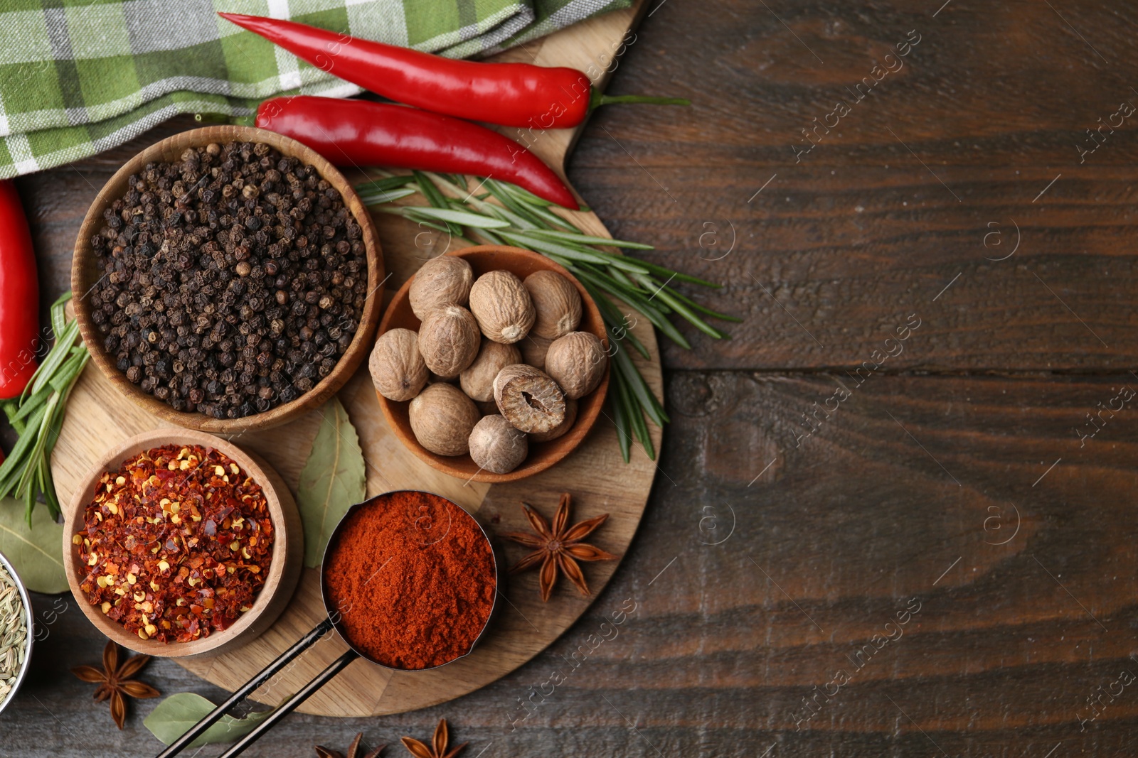 Different aromatic spices on wooden table, flat lay. Space for text Photo of Different aromatic spices on wooden table, flat lay. Space for text