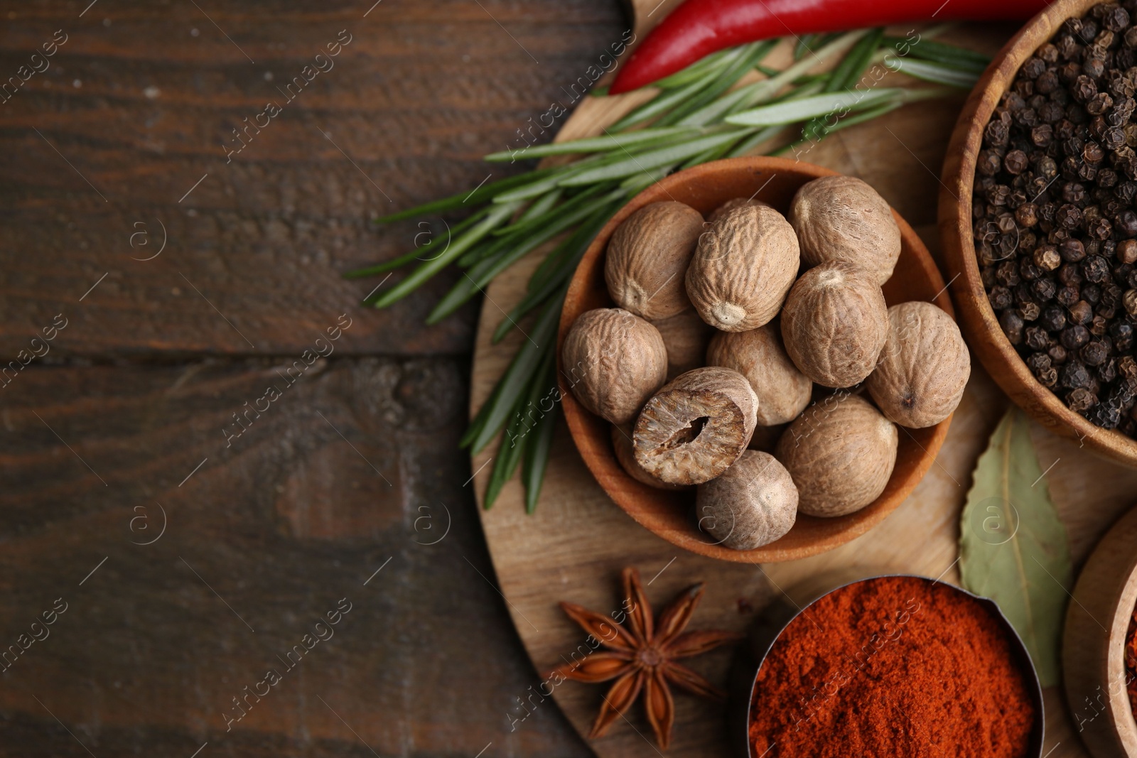 Different aromatic spices on wooden table, flat lay. Space for text Photo of Different aromatic spices on wooden table, flat lay. Space for text