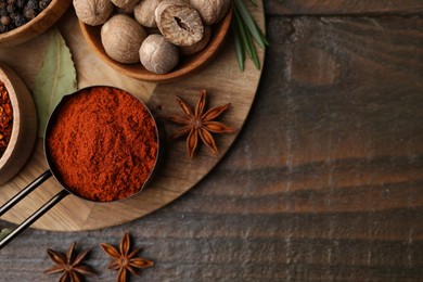 Photo of Different aromatic spices on wooden table, flat lay. Space for text