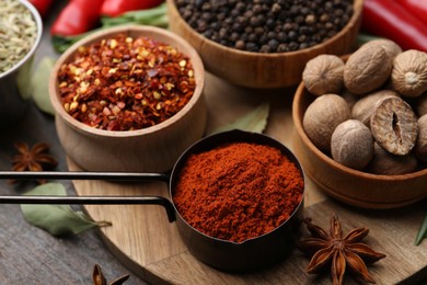 Photo of Different aromatic spices on wooden table, closeup
