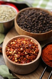 Photo of Different aromatic spices on wooden table, closeup