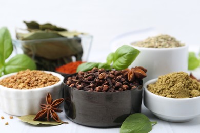 Photo of Different aromatic spices on white table, closeup