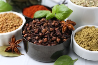 Photo of Different aromatic spices on white table, closeup