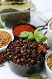 Photo of Different aromatic spices on white table, closeup