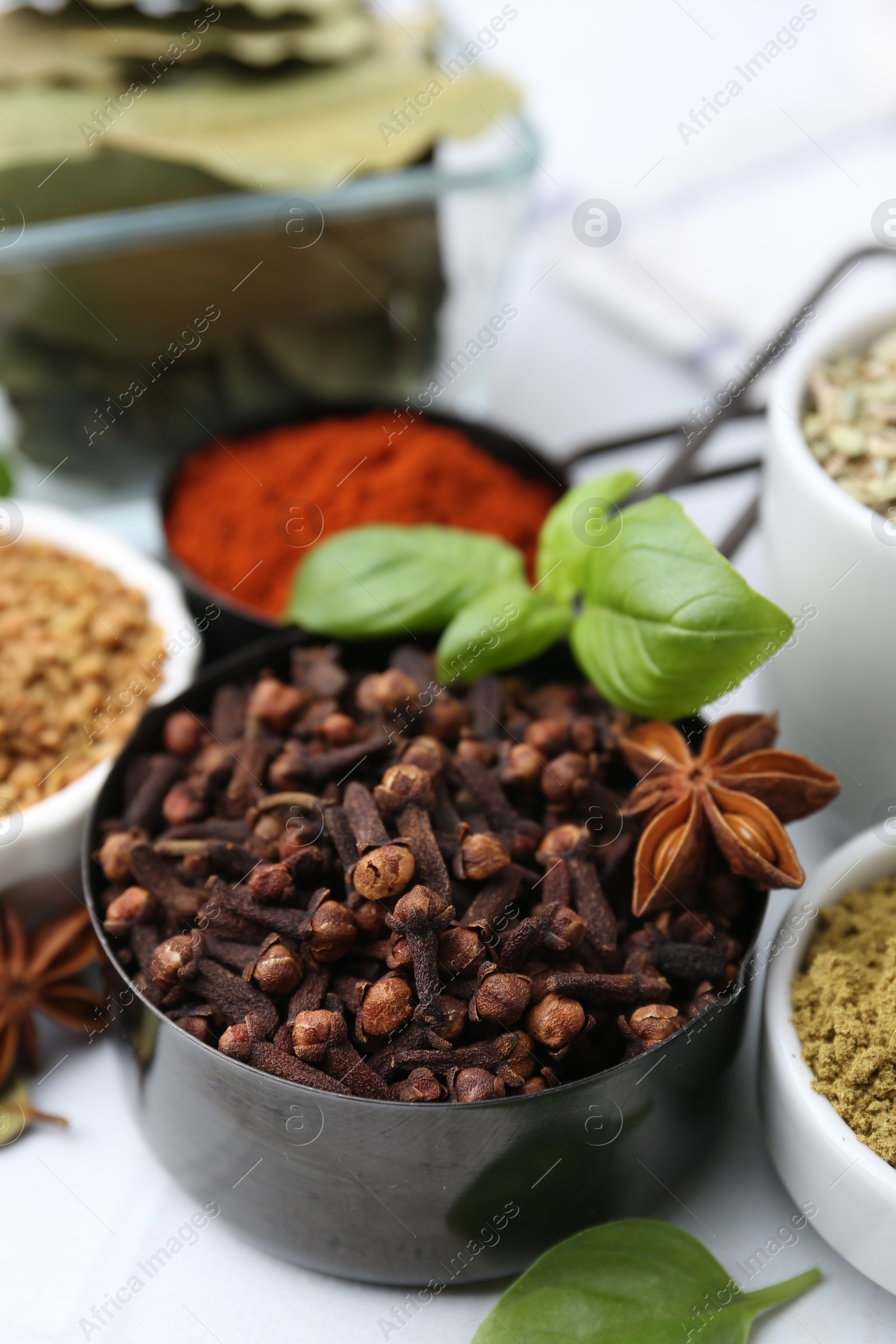 Different aromatic spices on white table, closeup Photo of Different aromatic spices on white table, closeup