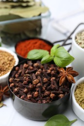Photo of Different aromatic spices on white table, closeup
