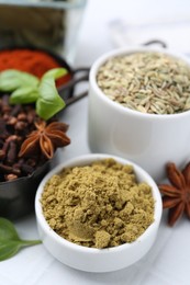Photo of Different aromatic spices on white table, closeup