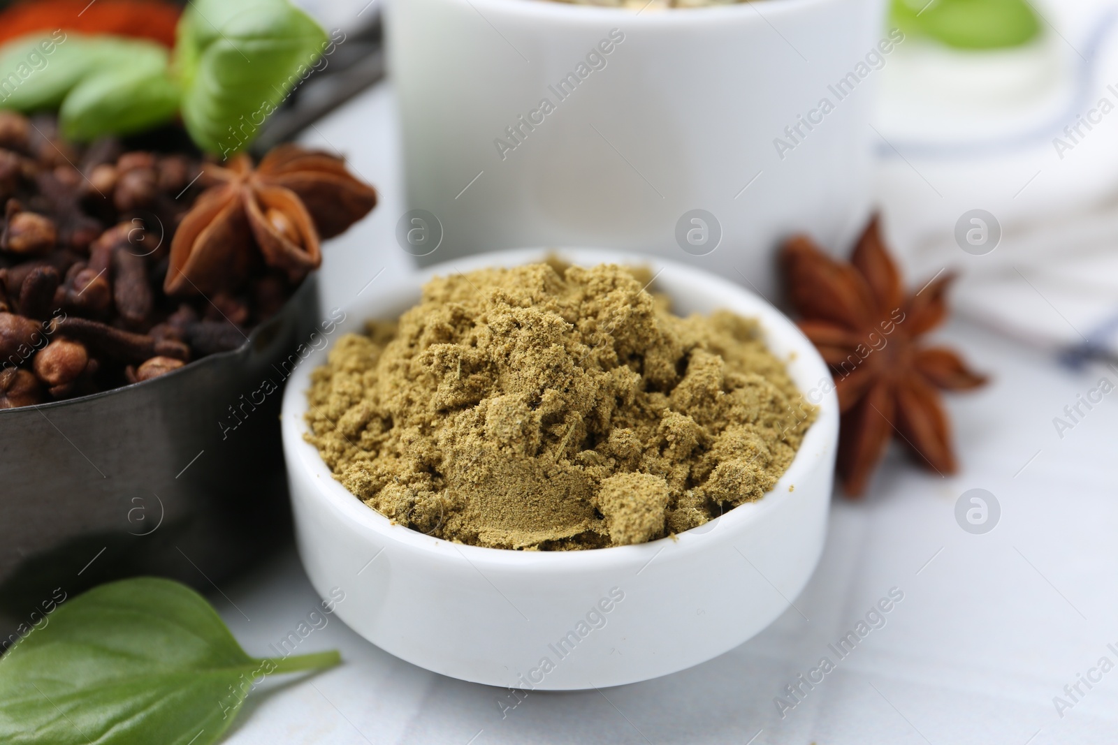 Different aromatic spices on white tiled table, closeup Photo of Different aromatic spices on white tiled table, closeup