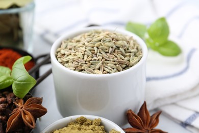 Photo of Different aromatic spices on white table, closeup
