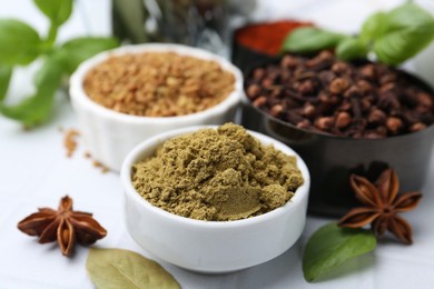 Photo of Different aromatic spices on white table, closeup