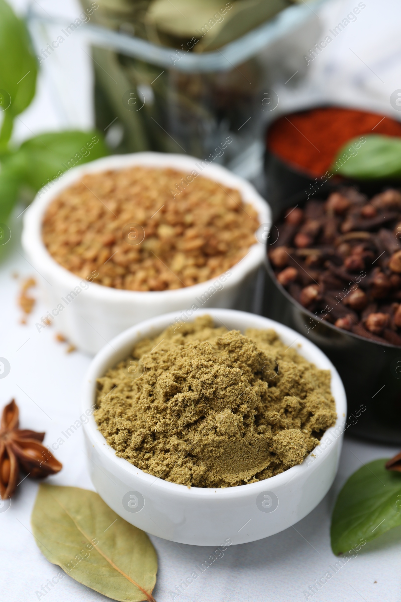 Different aromatic spices on white table, closeup Photo of Different aromatic spices on white table, closeup