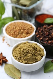 Photo of Different aromatic spices on white table, closeup