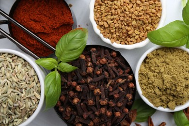 Photo of Different aromatic spices on white table, flat lay