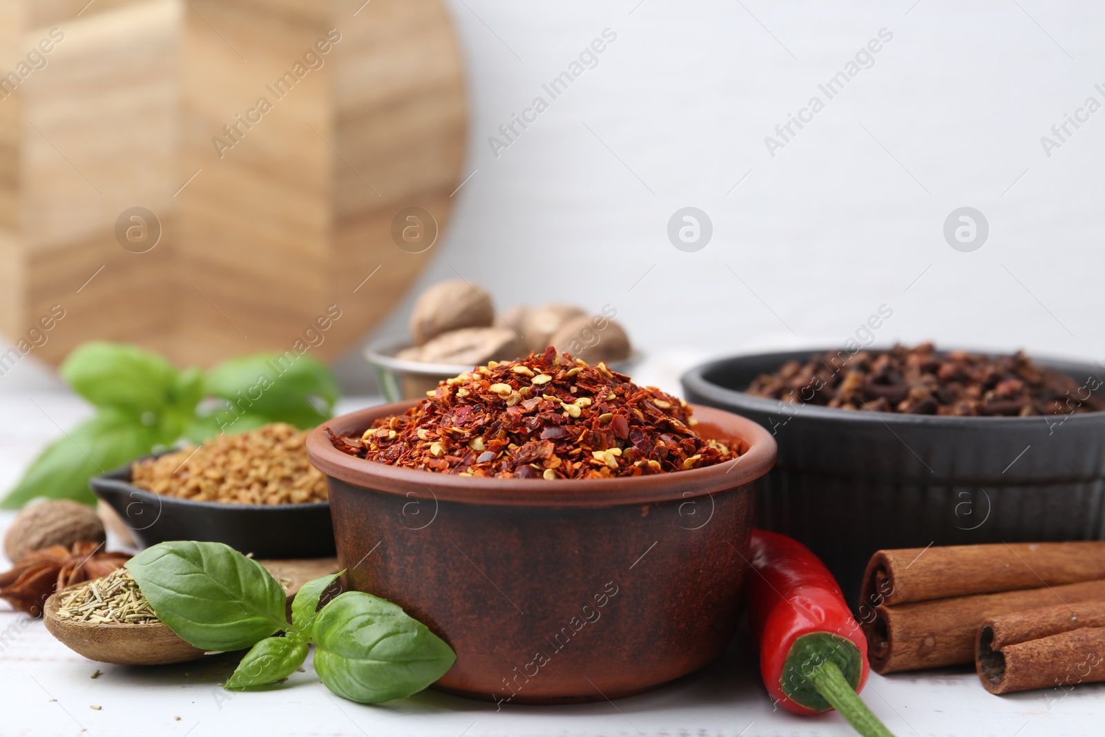 Different aromatic spices on white table, closeup. Space for text Photo of Different aromatic spices on white table, closeup. Space for text