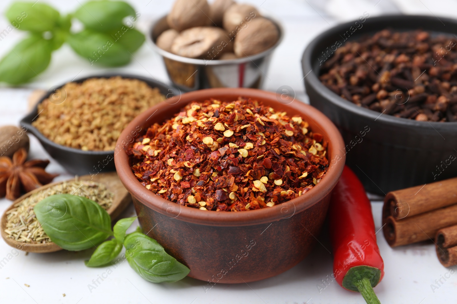 Different aromatic spices on white table, closeup Photo of Different aromatic spices on white table, closeup