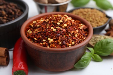 Photo of Different aromatic spices on white table, closeup