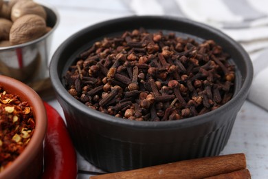 Photo of Different aromatic spices on white table, closeup