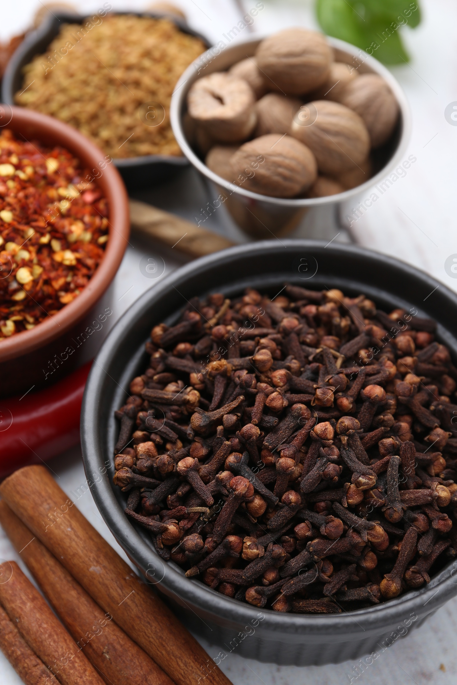 Different aromatic spices on white table, closeup Photo of Different aromatic spices on white table, closeup