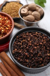 Photo of Different aromatic spices on white table, closeup