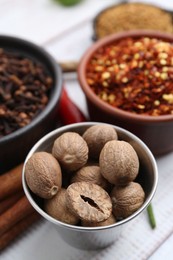 Photo of Different aromatic spices on white table, closeup
